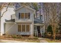 Charming two-story home featuring neutral siding, black shutters, and a welcoming front porch at 577 Woodbury, Pittsboro, NC 27312