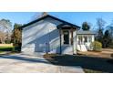 Side exterior view showcasing a well-maintained yard and modern siding at 5920 Holly Dr, Raleigh, NC 27616