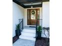 Inviting front entrance featuring a wood door with glass and a welcoming wreath at 5920 Holly Dr, Raleigh, NC 27616