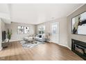 Bright living room with a fireplace, stylish furnishings, light gray colored walls and wood-look floors at 621 Bashford Rd, Raleigh, NC 27606