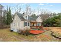 Charming single-Gathering home with a cozy front porch, green shutters, and landscaped yard at 673 Beck Ave, Henderson, NC 27536