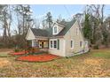 Charming single-Gathering home with a cozy front porch, green shutters, and landscaped yard at 673 Beck Ave, Henderson, NC 27536