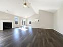 Spacious living room with dark wood floors, fireplace, and natural light at 70 Waterford Dr, Angier, NC 27501