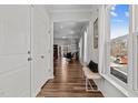 Bright hallway with hardwood floors leading to the dining area with natural light at 729 Colby Pl, Durham, NC 27713