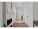 Entryway with hardwood floors, light gray walls, bench seating, and access to doors at 729 Colby Pl, Durham, NC 27713