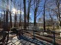 Relaxing backyard deck providing serene views of the calm lake waters through the trees at 8701 Oneal Rd, Raleigh, NC 27613