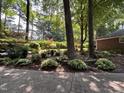 Beautifully landscaped yard with a mix of shrubs, flowers, and mature trees, creating a serene outdoor space at 8701 Oneal Rd, Raleigh, NC 27613