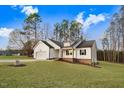 Beautiful white two-story home featuring lush green lawn, attached garage, and well-maintained landscaping at 9230 Bear Run Ln, Middlesex, NC 27557
