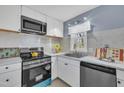 Modern kitchen with white cabinets, stainless steel appliances, and stylish countertop at 98 S Denise Ave, Coats, NC 27521