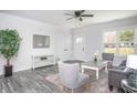 Bright living room featuring neutral walls, a ceiling fan, a gray loveseat, and wood-look flooring at 00 Cedar Grove Church Rd Rd, Roxboro, NC 27574