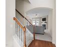 Inviting entryway with staircase leading to the upper level, and living area with a fireplace beyond at 109 Mainline Station Dr, Morrisville, NC 27560
