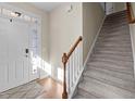 View of a front door and a carpeted staircase, creating a welcoming entrance space at 109 Mainline Station Dr, Morrisville, NC 27560