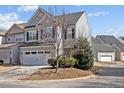 Exterior view of a two-story home with gray siding and a well-manicured lawn at 109 Mainline Station Dr, Morrisville, NC 27560