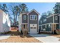 Modern two-story home with gray siding, white trim, and a concrete driveway at 1219 Chaney Rd, Raleigh, NC 27606