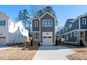 Gray two-story home with white trim, a one-car garage, and a concrete driveway at 1219 Chaney Rd, Raleigh, NC 27606