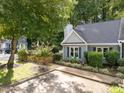 Charming home with light blue siding, mature trees, and a neat, fenced yard at 131 Carriage House Trl, Garner, NC 27529
