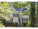 Attractive two-story home featuring a manicured lawn, complementary landscaping, and a brick front walkway at 1402 Princess Anne Rd, Cary, NC 27513