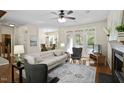 A spacious living room with hardwood flooring, a fireplace, and bright windows that provide ample natural light at 1402 Princess Anne Rd, Cary, NC 27513