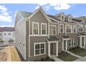Attractive townhome with brick and siding facade, large windows and manicured lawn at 231 Frosted Iris Lane Ln # 174, Garner, NC 27529
