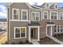 Charming townhome featuring brick and vertical siding, covered entrance, and large windows at 231 Frosted Iris Lane Ln # 174, Garner, NC 27529