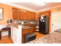 View of kitchen featuring wooden cabinets, granite countertops, and stainless steel appliances at 2701 Erinridge Road Rd, Raleigh, NC 27610