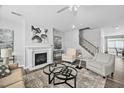 Stylish living room with fireplace, hardwood floors, and neutral paint at 2959 Sunflower Rd, Apex, NC 27502