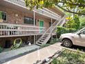 Exterior view of apartments with stairwells, patios, green door, and ample parking at 3 Shepherd Ln # Bldg C, Chapel Hill, NC 27514