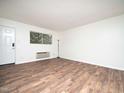 Bright living room with sleek wood flooring, a door, a large window, and an air conditioner at 3 Shepherd Ln # Bldg C, Chapel Hill, NC 27514