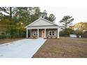 Inviting single-story home featuring a classic design and a well-maintained front yard at 302 S Eastwood Dr, Benson, NC 27504