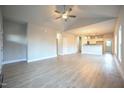 Spacious living room featuring vaulted ceilings, wood-look flooring, and ample natural light at 302 S Eastwood Dr, Benson, NC 27504