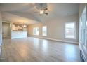 Bright open-concept living space with vaulted ceilings, abundant natural light, and wood-look flooring at 302 S Eastwood Dr, Benson, NC 27504