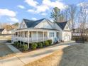 Beautiful home featuring a wraparound porch, a driveway, and an attached two-car garage at 304 Ashley Woods Ct, Clayton, NC 27527