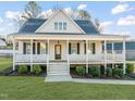 Inviting two-story home with a spacious front porch, manicured landscaping, and a welcoming entrance at 304 Ashley Woods Ct, Clayton, NC 27527