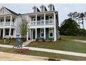 Elegant two-story home with a spacious covered porch and well-maintained landscaping at 304 White Oak Garden Way # 214, Garner, NC 27529