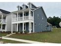 Beautiful two-story home featuring a covered front porch and attractive curb appeal at 304 White Oak Garden Way # 214, Garner, NC 27529