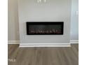 Close-up of the modern fireplace with sleek black frame in the living room at 304 White Oak Garden Way # 214, Garner, NC 27529