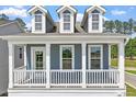 Welcoming front porch featuring white railings and columns, providing a cozy outdoor space at 304 White Oak Garden Way # 214, Garner, NC 27529
