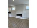 Bright living room featuring a modern fireplace and wood-look floors, creating a cozy atmosphere at 304 White Oak Garden Way # 214, Garner, NC 27529
