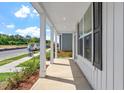 Spacious front porch featuring classic white columns, perfect for relaxing and enjoying the neighborhood scenery at 308 White Oak Garden Way # 215, Garner, NC 27529