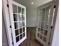 Bright office with glass French doors and wood-look floors, perfect for work at 308 White Oak Garden Way # 215, Garner, NC 27529