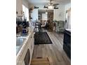 Open concept kitchen with modern appliances and a view into the living room area at 3607 Buffaloe Rd, Raleigh, NC 27604