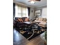 Comfortable living room with stylish sofas, dark wood floors, and natural light at 3607 Buffaloe Rd, Raleigh, NC 27604