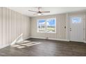 Inviting living room featuring hardwood floors, a ceiling fan, neutral walls, and a bright window at 3639 Nc Highway 39, Selma, NC 27576
