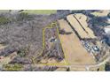 Aerial view shows approximate property lines of a private home nestled among trees and fields at 4639 Reid Rd, Elon, NC 27244