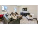 Bright living room with stylish furniture, modern decor, and large windows for natural light at 484 Barnes Landing Dr, Four Oaks, NC 27524