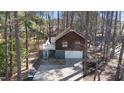 Aerial view of a home showcasing the driveway, wooded lot, and surrounding neighborhood at 701 Black Pearl Cv, Rocky Mount, NC 27804