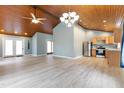 Open-concept living space featuring wood ceilings, hardwood floors and stainless steel appliances at 701 Black Pearl Cv, Rocky Mount, NC 27804