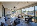 Relaxing screened porch features comfortable seating and views of the lake at 79 Cove Lndg, Sanford, NC 27332
