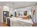 Open-concept kitchen features stainless steel appliances, a large island, and views to the living room at 83 Stickleback Dr, Willow Springs, NC 27592