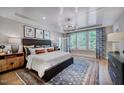 Spacious main bedroom featuring a tray ceiling, modern light fixture, and stylish decor at 83 Stickleback Dr, Willow Springs, NC 27592